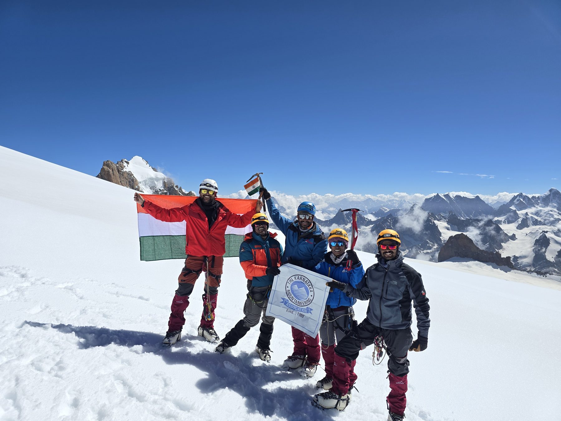 Expedition team celebrating on a Himalayan summit